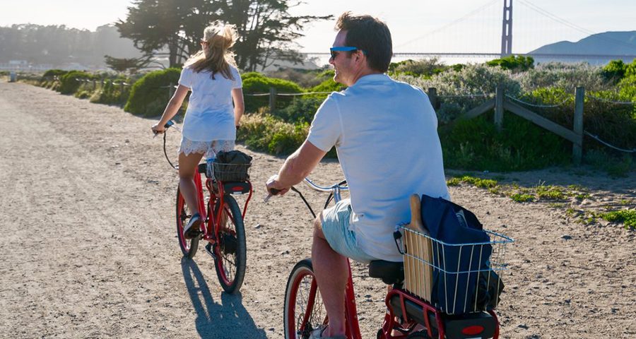 Couple Biking Through Golden Gate Park