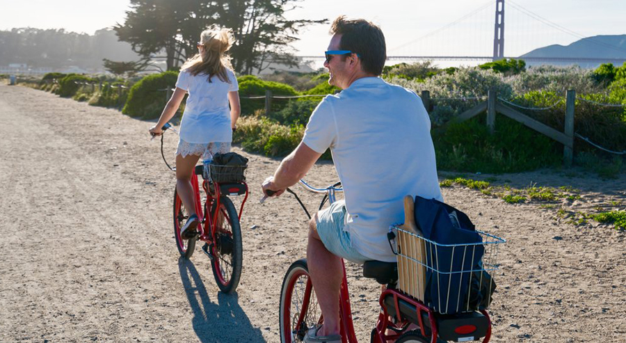 Couple Biking Through Golden Gate Park